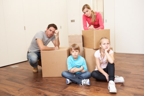 Professional movers handling household items for a local removals service